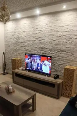 a living room with a flat screen tv on a wall at Residence Miramas 2 D in Marrakech
