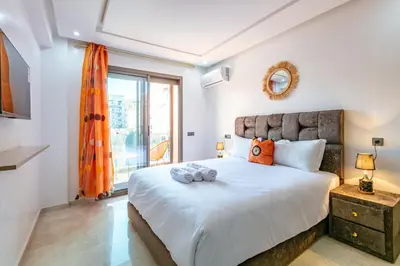 a bedroom with a large bed and a window at New ! Appartement Bella ,Terrasse,Fibre Obtique in Marrakech