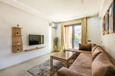 a living room with a couch and a tv at New ! Appartement Bella ,Terrasse,Fibre Obtique in Marrakech