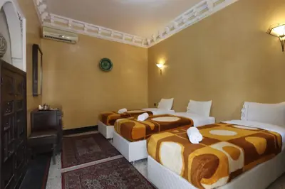 a hotel room with three beds in a room at HOTEL CTM in Marrakech