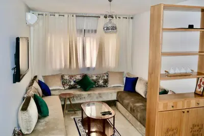 a living room with a couch and a table at Studio cosy au centre de Marrakech in Marrakech