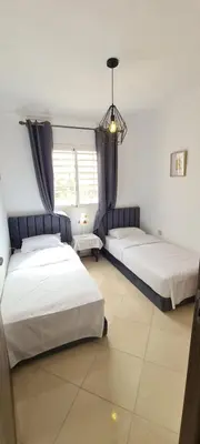 a bedroom with two beds and a window at Entre ville et détente- les portes de Guéliz in Marrakech