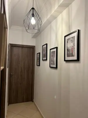 a hallway with a door and pictures on the wall at Entre ville et détente- les portes de Guéliz in Marrakech