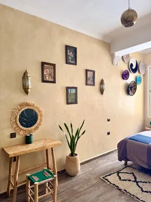 a bedroom with a bed and a table with a mirror at Maison Mamdy Rooftop in Marrakech