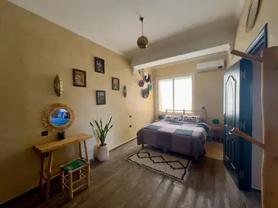 a bedroom with a bed and a window at Maison Mamdy Rooftop in Marrakech