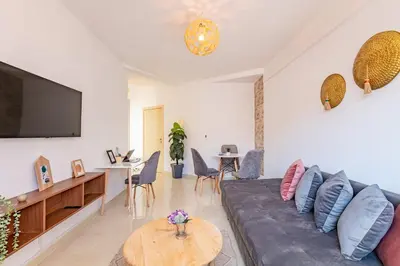 a living room with a couch and a flat screen tv at Marrakech kamed home in Marrakech