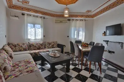 a living room with a couch and a table at Résidence Assiyahia avec piscine Marrakech in Marrakech