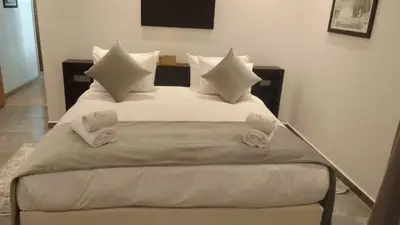 a bedroom with a bed with white sheets and pillows at Domaine K Marrakech in Marrakech