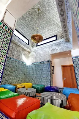 a room with colorful stools in a room with a ceiling at Domaine K Marrakech in Marrakech