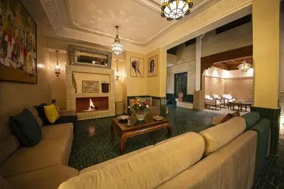 a living room with a couch and a fireplace at Riad Atrium & Spa in Marrakech