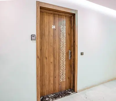 a wooden door with a on it at appartement piscine proche gare in Marrakech
