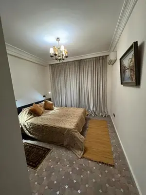 a bedroom with a bed and a chandelier at Luxury apartment 3 in the heart of Gueliz, Wifi, Pool in Marrakech