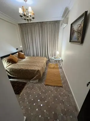 a bedroom with a bed and a table in it at Luxury apartment 3 in the heart of Gueliz, Wifi, Pool in Marrakech