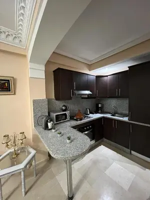a kitchen with a table in the middle of it at Luxury apartment 3 in the heart of Gueliz, Wifi, Pool in Marrakech