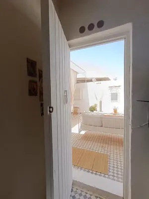 a door leading to a balcony with a view of a patio at STUDIO BLANCO MÉDINA AVEC TERRASSE in Marrakech