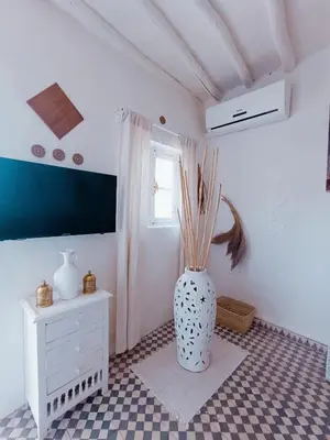 a white vase sitting on a floor in a room at STUDIO BLANCO MÉDINA AVEC TERRASSE in Marrakech