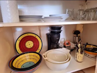 a shelf with plates and other dishes on it at STUDIO BLANCO MÉDINA AVEC TERRASSE in Marrakech