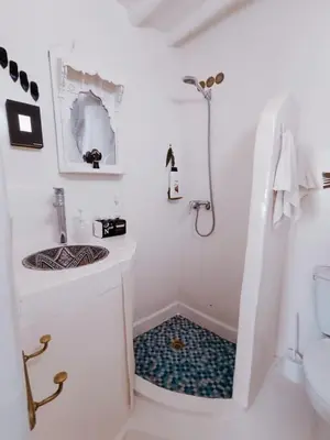 a white bathroom with a sink and a toilet at STUDIO BLANCO MÉDINA AVEC TERRASSE in Marrakech