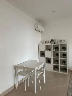 a white dining room with a table and chairs at Gueliz Center Home (Starbucks) in Marrakech