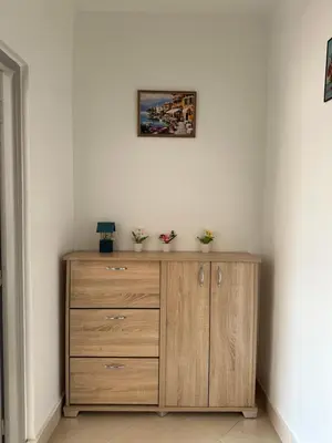 a wooden dresser in a corner of a room at Gueliz Center Home (Starbucks) in Marrakech