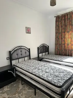 two beds sitting next to each other in a room at Gueliz Center Home (Starbucks) in Marrakech