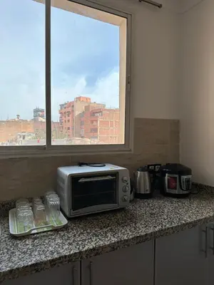 a microwave sitting on a counter in a kitchen with a window at Gueliz Center Home (Starbucks) in Marrakech