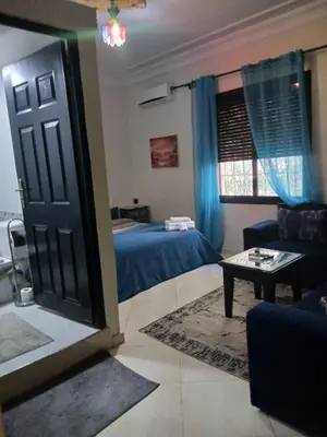 a room with a bed and a door and a couch at Paradise house in Marrakech