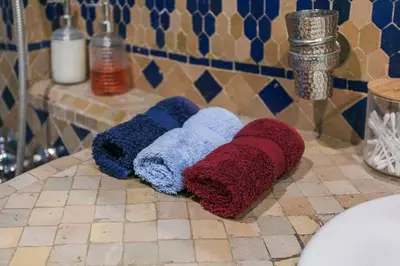 two towels sitting on a counter in a bathroom at Gueliz Gala – Marrakech Centre in Marrakech