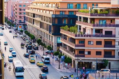 a busy city street with cars and buildings at Gueliz Gala – Marrakech Centre in Marrakech