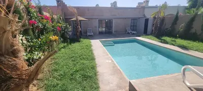 a swimming pool in the yard of a house at city garden Kech in Marrakech