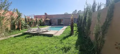 a yard with two chairs and a swimming pool at city garden Kech in Marrakech