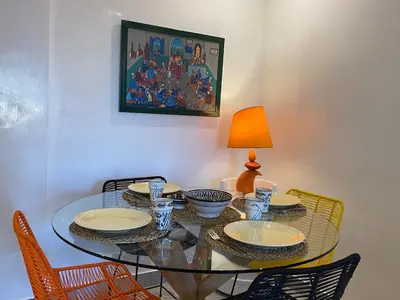 a glass dining room table with chairs and a lamp at Rooftop Pool, Atlas View, M avenue in Marrakech