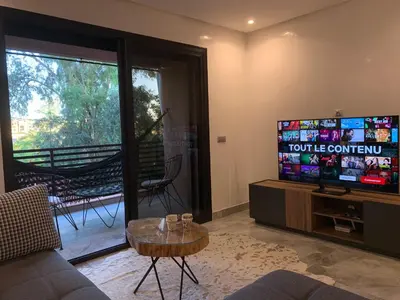 a living room with a couch and a flat screen tv at Rooftop Pool, Atlas View, M avenue in Marrakech