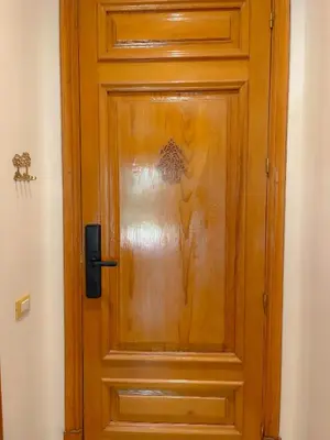 a wooden door with a sticker on it at Au cœur de la palmeraie de Marrakech in Marrakech