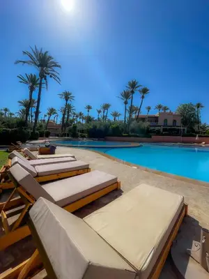 a pool with chaise lounge chairs and a swimming pool at Au cœur de la palmeraie de Marrakech in Marrakech