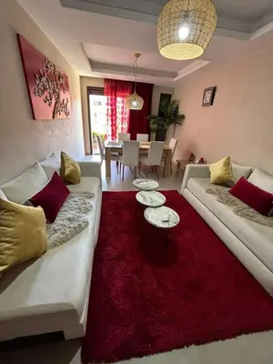 a living room with two couches and a red rug at Appartement neuf climatisé, centre Marrakech. in Marrakech