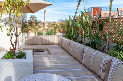 a patio with a couch and some plants at Riad K-white in Marrakech