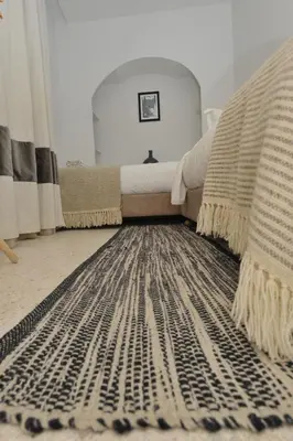 a room with a couch and a rug on the floor at Riad K-white in Marrakech