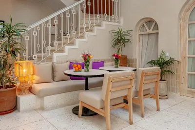 a living room with a table and a couch at Riad K-white in Marrakech