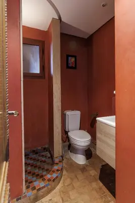 a bathroom with a toilet and a sink and a tub at Alqantara in Marrakech