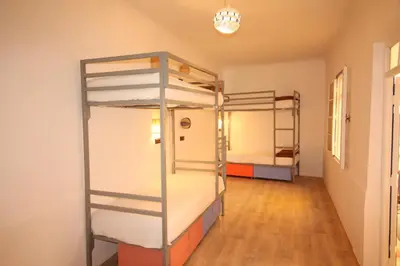 a room with two bunk beds and a hallway at El Boussouni Hostel in Marrakech
