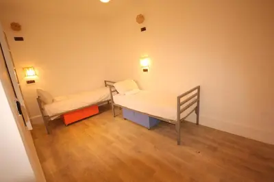 a hospital room with a bed and a chair at El Boussouni Hostel in Marrakech