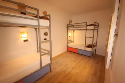 a room with two bunk beds and a hallway at El Boussouni Hostel in Marrakech