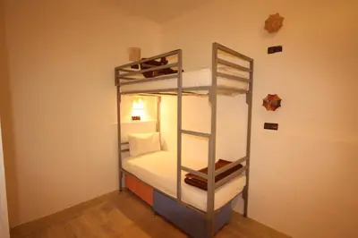 a bedroom with a bunk bed with a ladder at El Boussouni Hostel in Marrakech