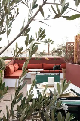 a patio with a couch and a table and chairs at Riad Al Uzza in Marrakech