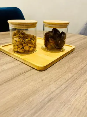 two jars of nuts on a wooden tray on a table at Stay In Marrakech Blue Appartment in Marrakech