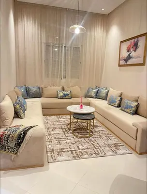 a living room with a couch and a table at Stay In Marrakech Blue Appartment in Marrakech