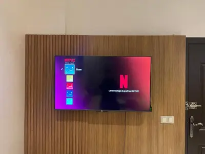 a flat screen tv on top of a wooden door at Stay In Marrakech Blue Appartment in Marrakech