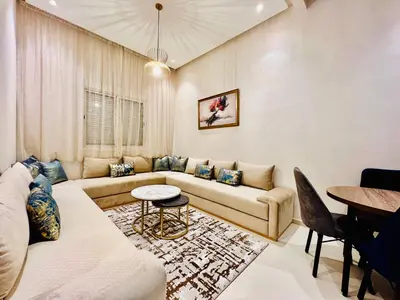 a living room with a couch and a table at Stay In Marrakech Blue Appartment in Marrakech
