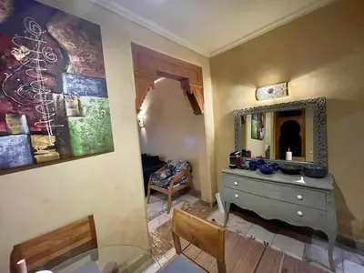 a room with a dresser and a mirror on the wall at Les Fleurs du Bien - Marrakech in Marrakech